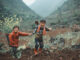 2 Hmong babies picked up the dirt